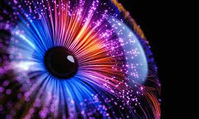 Colorful abstract eye with vibrant blue, purple, pink, and orange light streaks radiating from the pupil, creating a dynamic and energetic visual effect against a dark background